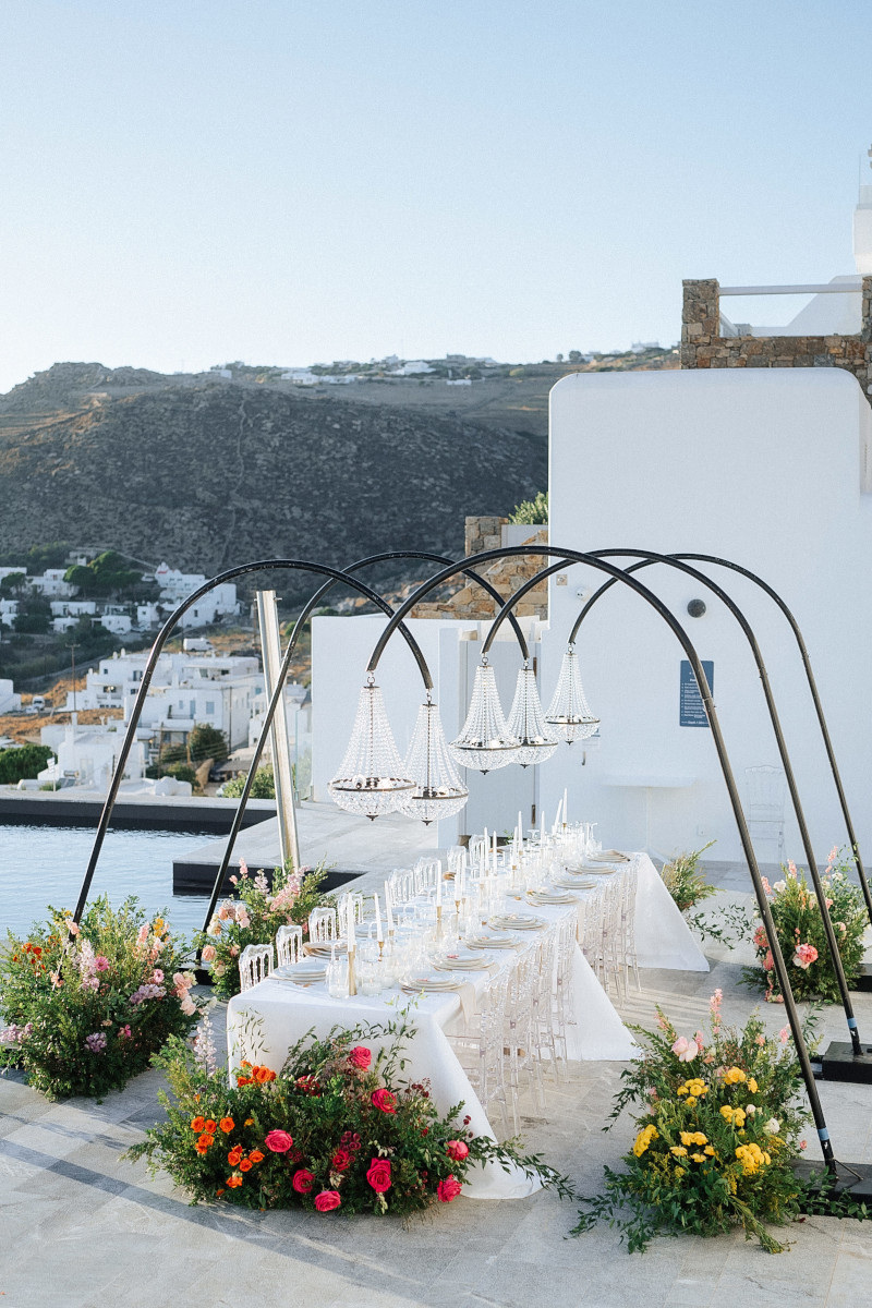 Luxury Mykonos wedding venue with outdoor reception table and floral decorations.
