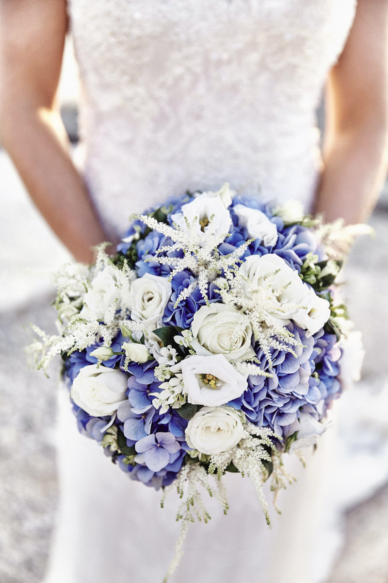 A stunning blue and white wedding bouquet filled with beautiful flowers for a Mykonos wedding.
