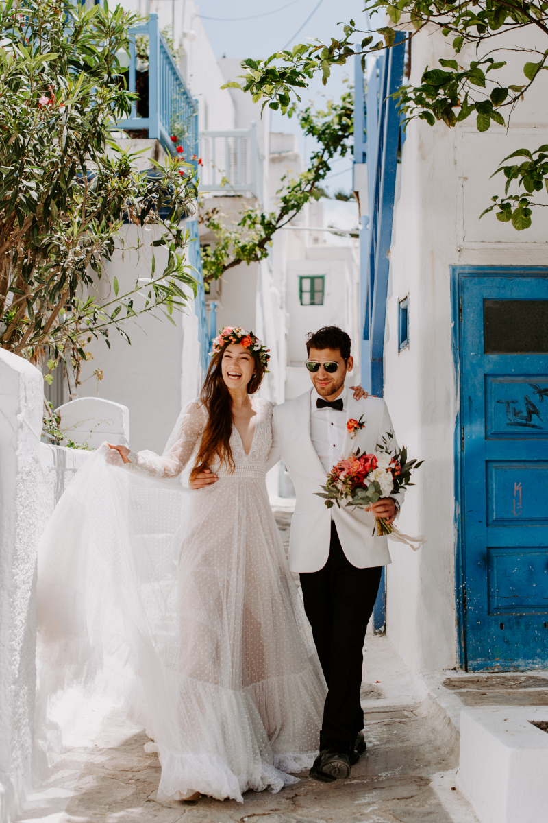 A professional photographer capturing a dream destination wedding in Mykonos Town, Greece.