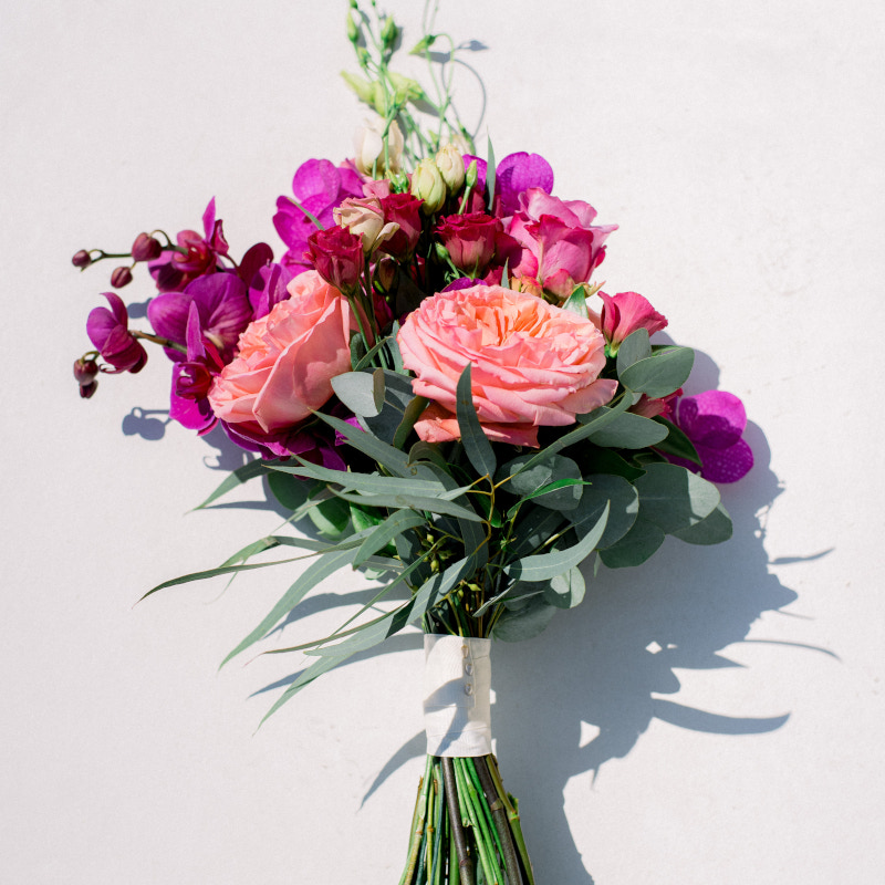 Mykonos wedding blog features stunning pink and purple flower bouquet.